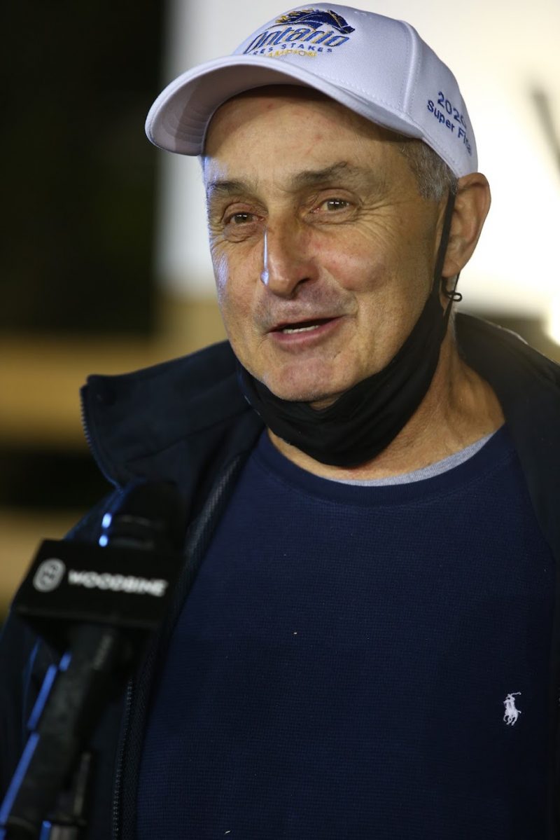 Ben Baillargeon speaking into a microphone following the 2020 Ontario Sires Stakes Super Finals.